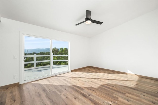 1563 Gary Ln, Redlands, CA 92374 - unfurnished room with wood finished floors, a mountain view, and ceiling fan