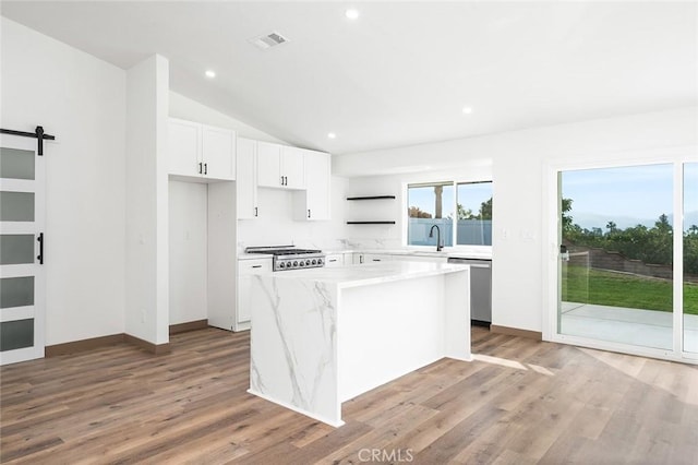 1563 Gary Ln, Redlands, CA 92374 - kitchen featuring appliances with stainless steel finishes, a sink, a kitchen island, white cabinets, and open shelves