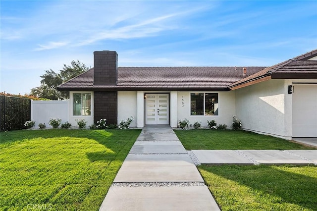 1563 Gary Ln, Redlands, CA 92374 - view of front of house featuring french doors, stucco siding, a chimney, and a garage