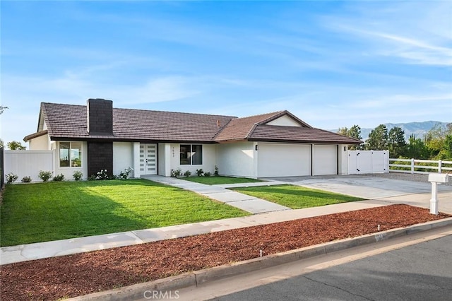 1563 Gary Ln, Redlands, CA 92374 - single story home featuring an attached garage, driveway, stucco siding, a tile roof, and a mountain view