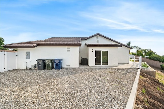 1563 Gary Ln, Redlands, CA 92374 - rear view of property featuring cooling unit, stucco siding, a patio, a gate, and electric panel