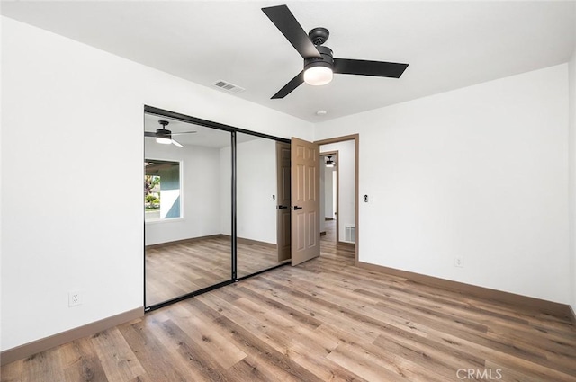 1563 Gary Ln, Redlands, CA 92374 - unfurnished bedroom featuring wood finished floors, a closet, baseboards, and ceiling fan