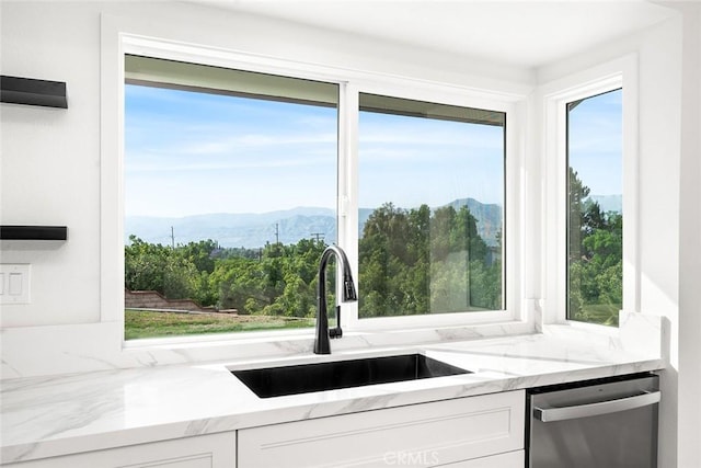 1563 Gary Ln, Redlands, CA 92374 - kitchen with stainless steel dishwasher, a sink, a mountain view, and white cabinetry