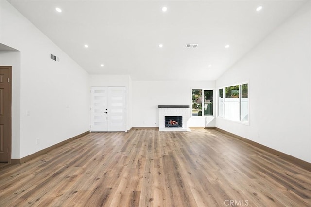 1563 Gary Ln, Redlands, CA 92374 - unfurnished living room featuring light wood-style flooring, recessed lighting, a fireplace, high vaulted ceiling, and baseboards