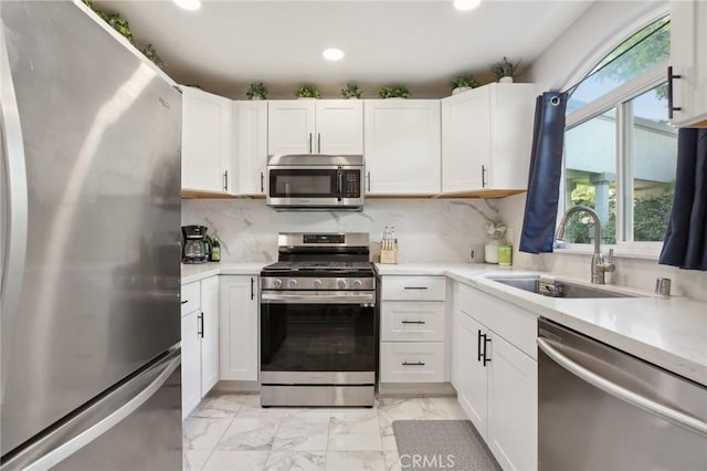 30902 Clubhouse Dr Unit 27D, Laguna Niguel, CA 92677 - kitchen featuring appliances with stainless steel finishes, healthy amount of natural light, light marble finish flooring, light countertops, and recessed lighting