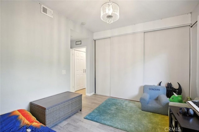 30902 Clubhouse Dr Unit 27D, Laguna Niguel, CA 92677 - bedroom featuring light wood-style flooring, a chandelier, and a closet