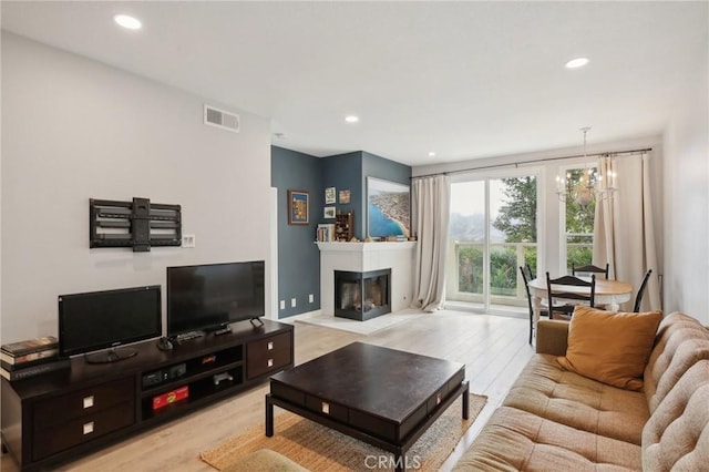 30902 Clubhouse Dr Unit 27D, Laguna Niguel, CA 92677 - living room with light wood-style floors, recessed lighting, and a glass covered fireplace