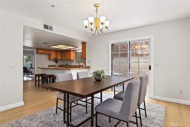 609 E Newmark Ave, Monterey Park, CA 91755 - dining area with a chandelier and light wood-type flooring