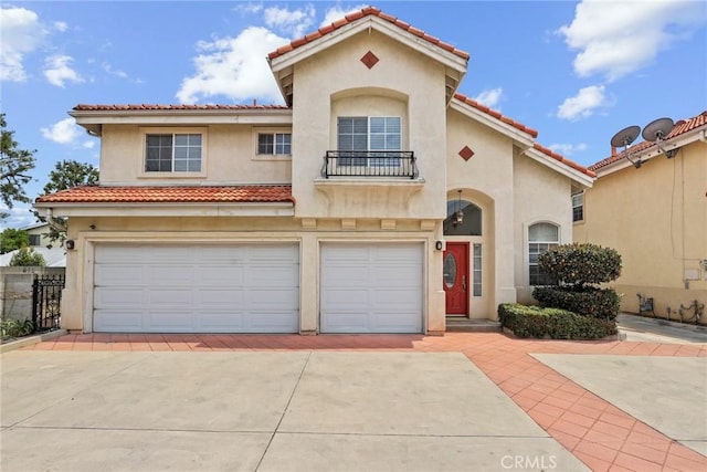 609 E Newmark Ave, Monterey Park, CA 91755 - mediterranean / spanish-style house with a garage, driveway, stucco siding, and a balcony
