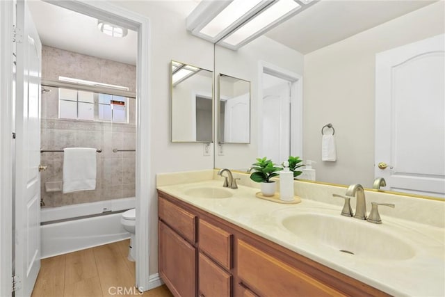609 E Newmark Ave, Monterey Park, CA 91755 - bathroom with double vanity, combined bath / shower with glass door, and wood finished floors