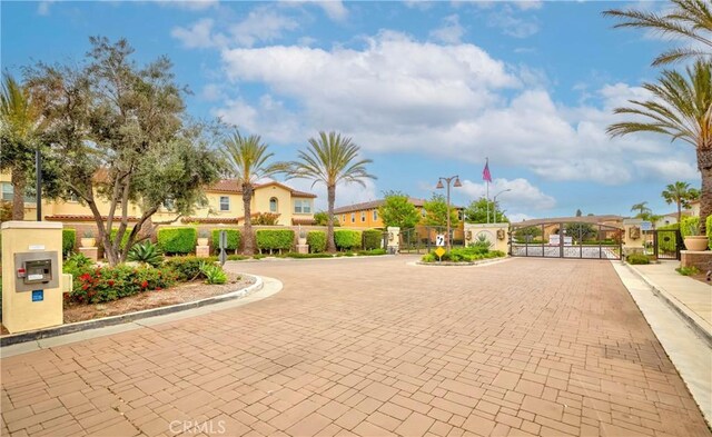 10410 Orchid Way, Santa Fe Springs, CA 90670 - view of decorative road featuring a gate, curbs, and a gated entry