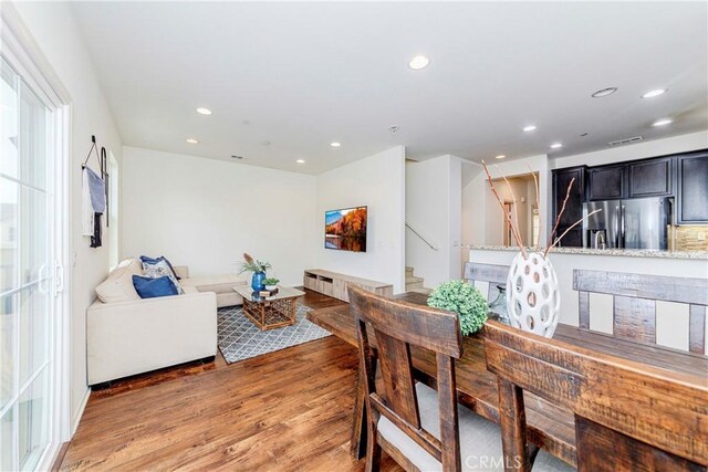 10410 Orchid Way, Santa Fe Springs, CA 90670 - dining room with light wood-style floors, recessed lighting, and stairway