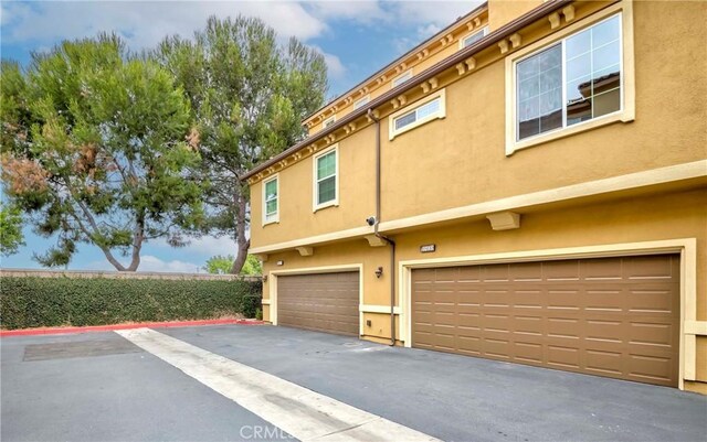 10410 Orchid Way, Santa Fe Springs, CA 90670 - view of property exterior with stucco siding and an attached garage