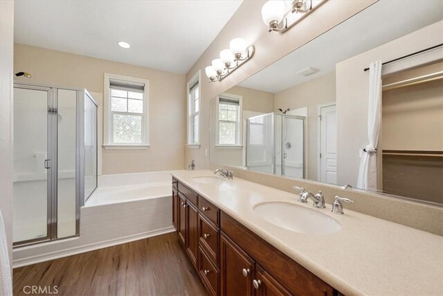 11506 Cuervo Way, Atascadero, CA 93422 - full bathroom with a stall shower, a bath, wood finished floors, double vanity, and recessed lighting