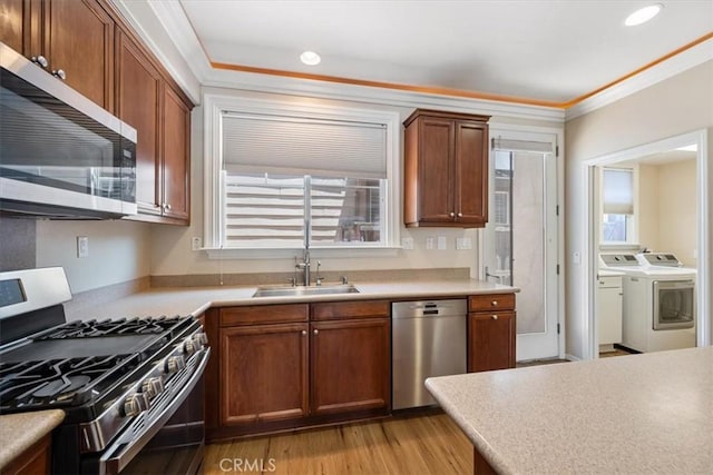 11506 Cuervo Way, Atascadero, CA 93422 - kitchen featuring stainless steel appliances, a sink, independent washer and dryer, crown molding, and light countertops