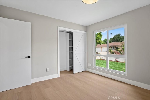 2014 Cumberland Rd, Glendora, CA 91741 - unfurnished bedroom with wood finished floors, baseboards, multiple windows, and a closet