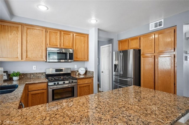 1324 Soundview Cir, Corona, CA 92881 - kitchen featuring appliances with stainless steel finishes, light stone counters, a peninsula, and recessed lighting