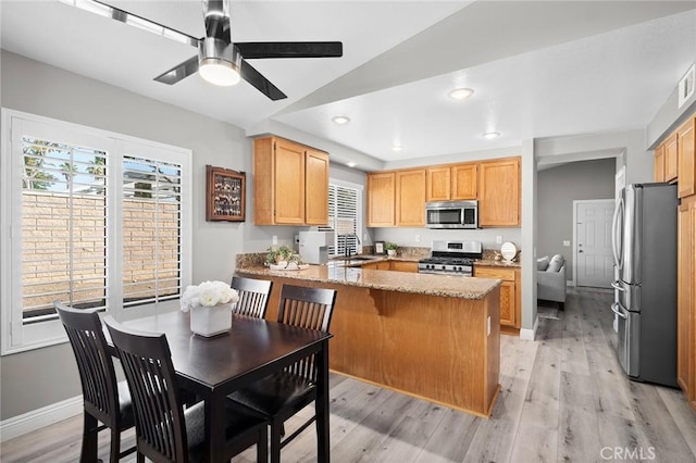 1324 Soundview Cir, Corona, CA 92881 - kitchen featuring appliances with stainless steel finishes, a peninsula, plenty of natural light, light stone counters, and recessed lighting