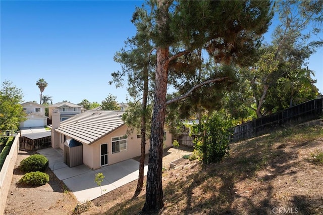 1324 Soundview Cir, Corona, CA 92881 - back of property featuring a fenced backyard, a patio area, stucco siding, and a tile roof