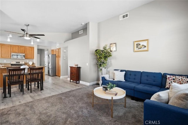 1324 Soundview Cir, Corona, CA 92881 - living room with lofted ceiling, ceiling fan, light carpet, baseboards, and light wood-type flooring