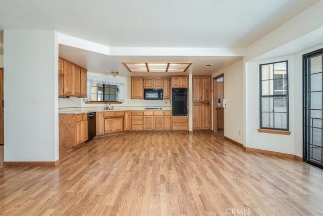 312 Crystal Cir, Lompoc, CA 93436 - kitchen featuring black appliances, light wood-type flooring, baseboards, and a warming drawer