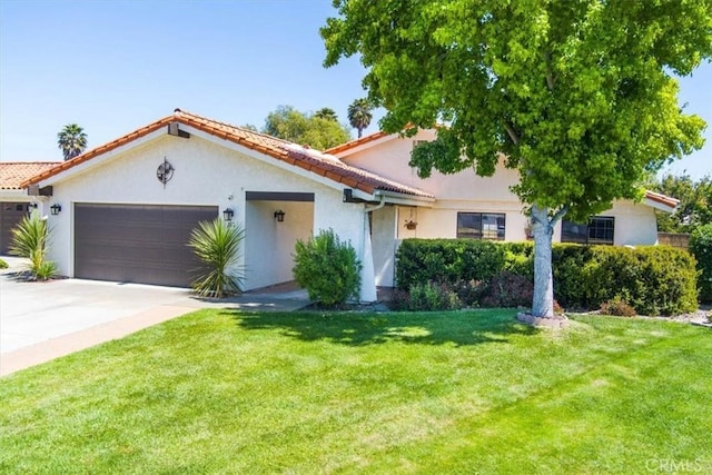 312 Crystal Cir, Lompoc, CA 93436 - mediterranean / spanish-style home with a garage, stucco siding, concrete driveway, a front lawn, and a tiled roof