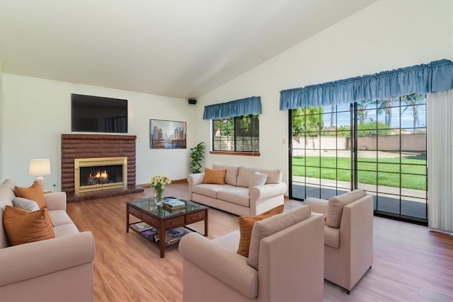 312 Crystal Cir, Lompoc, CA 93436 - living room with lofted ceiling, light wood-style floors, and a fireplace