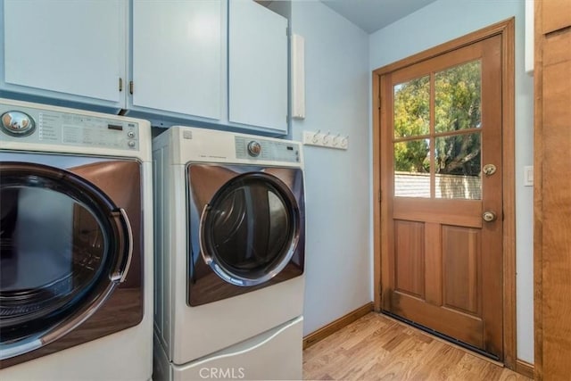 312 Crystal Cir, Lompoc, CA 93436 - laundry room featuring washer and clothes dryer, cabinet space, light wood-style flooring, and baseboards