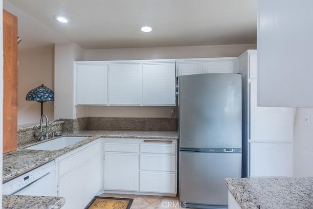 25847 Mcbean Pkwy Unit 25, Valencia, CA 91355 - kitchen featuring freestanding refrigerator, a sink, white cabinetry, light stone countertops, and recessed lighting