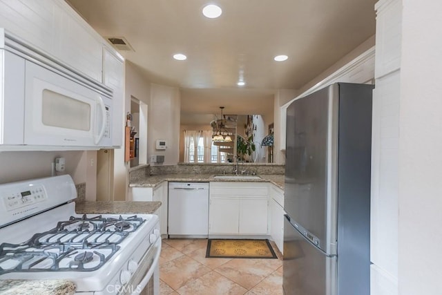 25847 Mcbean Pkwy Unit 25, Valencia, CA 91355 - kitchen with white appliances, a sink, white cabinets, recessed lighting, and light stone countertops