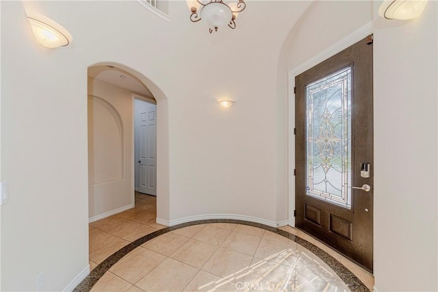 211 Franklin Ave, Redlands, CA 92373 - entryway with inlaid floor details, arched walkways, baseboards, and a chandelier