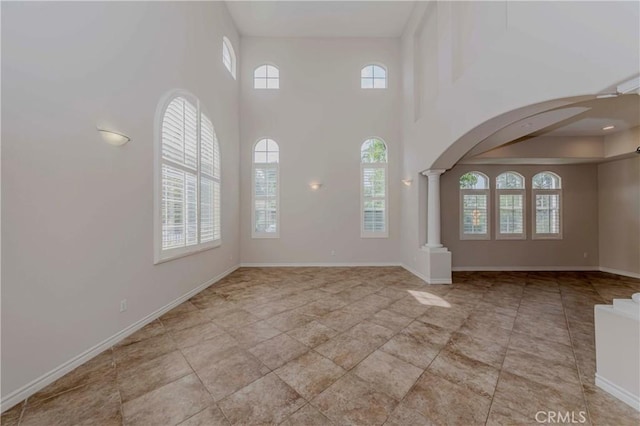 211 Franklin Ave, Redlands, CA 92373 - entryway with plenty of natural light, ornate columns, arched walkways, a high ceiling, and baseboards