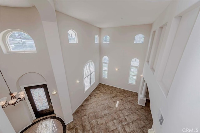 211 Franklin Ave, Redlands, CA 92373 - foyer featuring a high ceiling, baseboards, and stone finish flooring