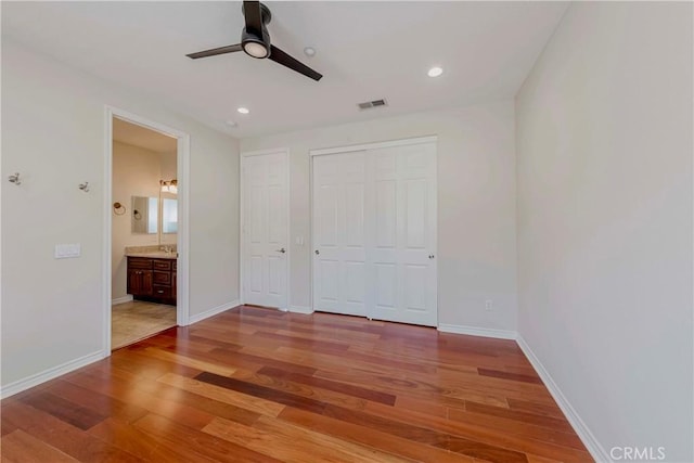 211 Franklin Ave, Redlands, CA 92373 - unfurnished bedroom with wood finished floors, recessed lighting, baseboards, and ensuite bath
