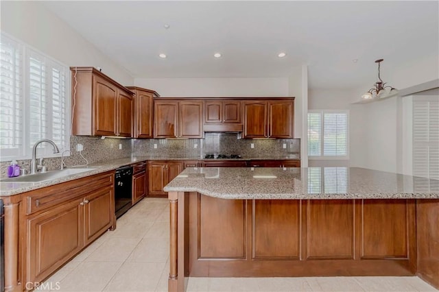 211 Franklin Ave, Redlands, CA 92373 - kitchen featuring a sink, under cabinet range hood, black appliances, light stone counters, and tasteful backsplash