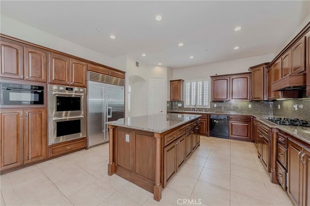 211 Franklin Ave, Redlands, CA 92373 - kitchen with black appliances, decorative backsplash, a center island, light tile patterned floors, and recessed lighting