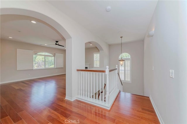211 Franklin Ave, Redlands, CA 92373 - corridor featuring wood finished floors, baseboards, an upstairs landing, and arched walkways