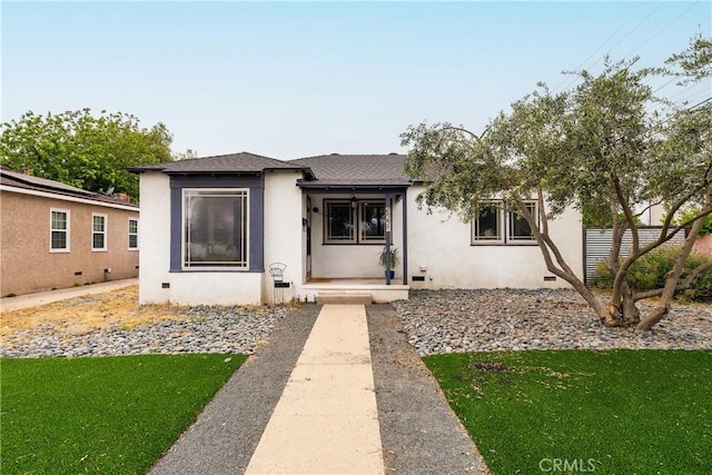 6557 Clybourn Ave, North Hollywood, CA 91606 - view of front facade featuring stucco siding, roof with shingles, and a front lawn