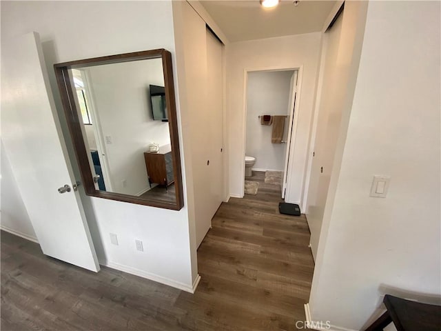 17722 Sergio Cir Unit 203, Huntington Beach, CA 92647 - hall featuring dark wood-style flooring and baseboards