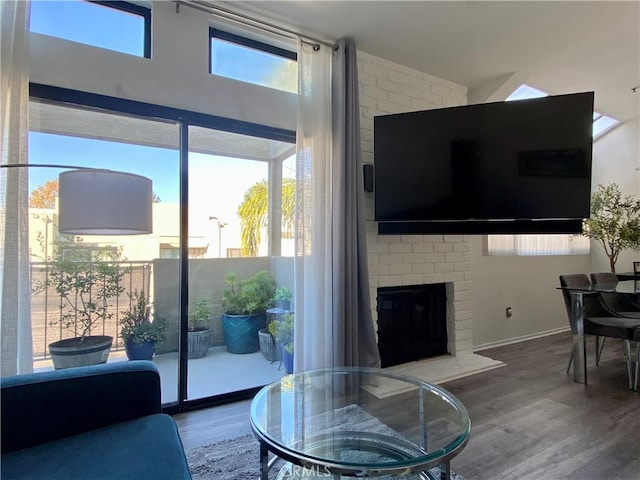 17722 Sergio Cir Unit 203, Huntington Beach, CA 92647 - living area featuring wood finished floors and a fireplace