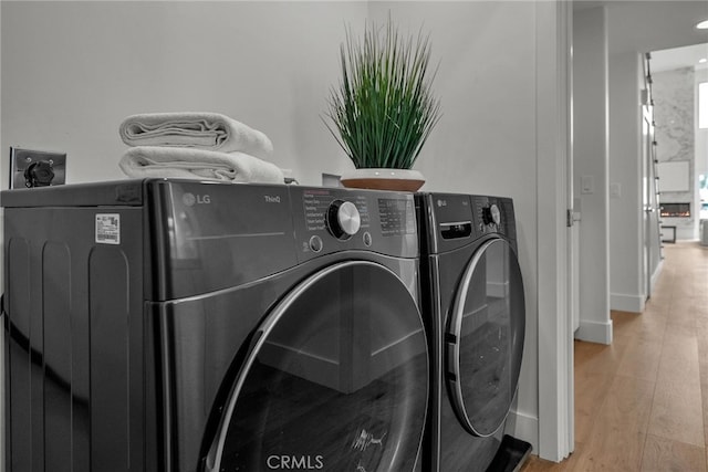 200 S Catalina Ave Unit 403, Redondo Beach, CA 90277 - laundry area with separate washer and dryer, light wood-style flooring, and baseboards
