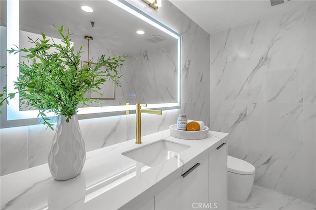 200 S Catalina Ave Unit 403, Redondo Beach, CA 90277 - bathroom with vanity, toilet, marble finish floors, recessed lighting, and tile walls