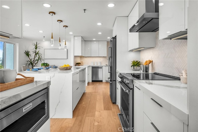 200 S Catalina Ave Unit 403, Redondo Beach, CA 90277 - kitchen with modern cabinets, stainless steel appliances, wall chimney exhaust hood, white cabinetry, and light wood-style floors