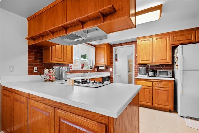 1426 E Colver Pl, Covina, CA 91724 - kitchen with freestanding refrigerator, extractor fan, tasteful backsplash, gas stovetop, and light countertops