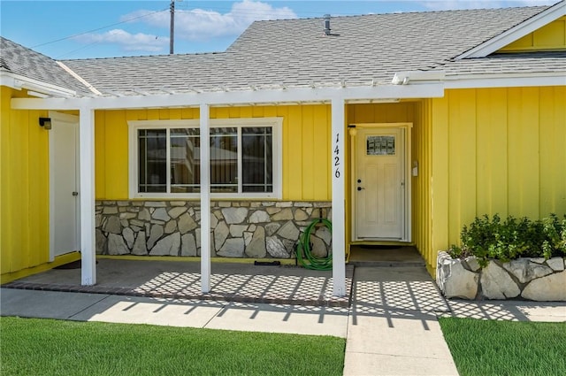 1426 E Colver Pl, Covina, CA 91724 - view of exterior entry featuring roof with shingles, stone siding, and covered porch