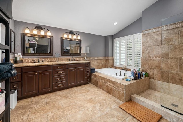 4520 Tarantella Ln, San Diego, CA 92130 - full bathroom featuring lofted ceiling, double vanity, a bath, recessed lighting, and stone finish floors