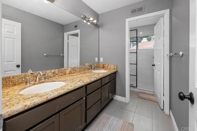 4520 Tarantella Ln, San Diego, CA 92130 - full bath with baseboards, double vanity, a stall shower, and tile patterned flooring