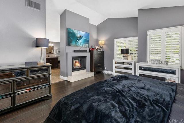 4520 Tarantella Ln, San Diego, CA 92130 - bedroom featuring vaulted ceiling, a tile fireplace, wood finished floors, ensuite bathroom, and baseboards