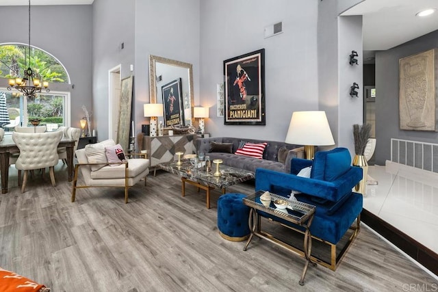 4520 Tarantella Ln, San Diego, CA 92130 - living room featuring a chandelier, wood finished floors, and a towering ceiling