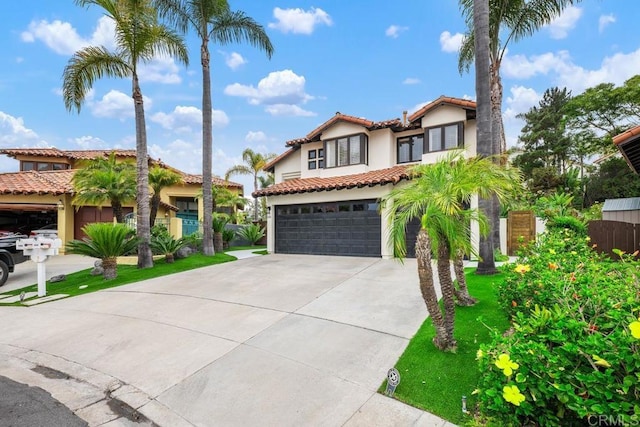 4520 Tarantella Ln, San Diego, CA 92130 - mediterranean / spanish house with stucco siding, concrete driveway, a tiled roof, and an attached garage